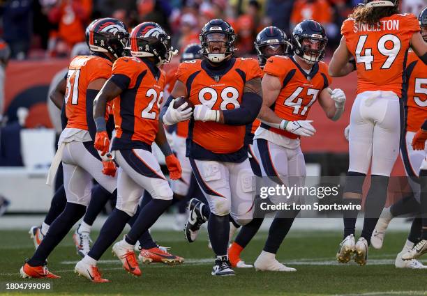 Denver Broncos defensive lineman Mike Purcell celebrates after recovering a fumble during an NFL game between the Cleveland Browns and the Denver...