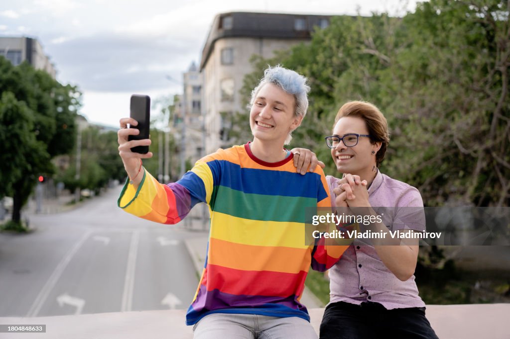 Homosexual couple making selfie for on the way to pride event