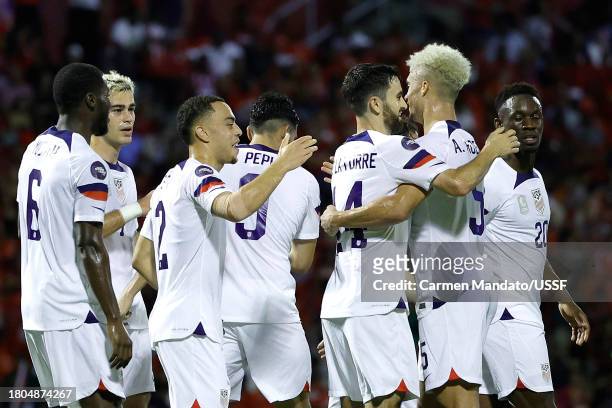 Antonee Robinson of the United States celebrates scoring with teammates during the first half against Trinidad and Tobago at Hasely Crawford Stadium...