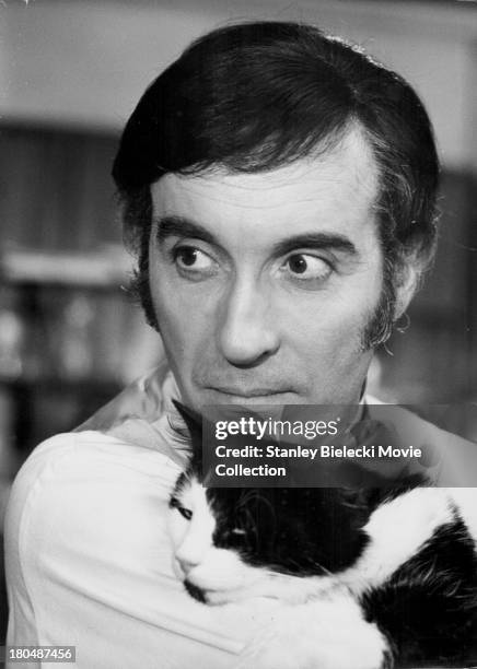 Actor Christopher Lee with a cat in a scene from the movie 'I, Monster', 1971.