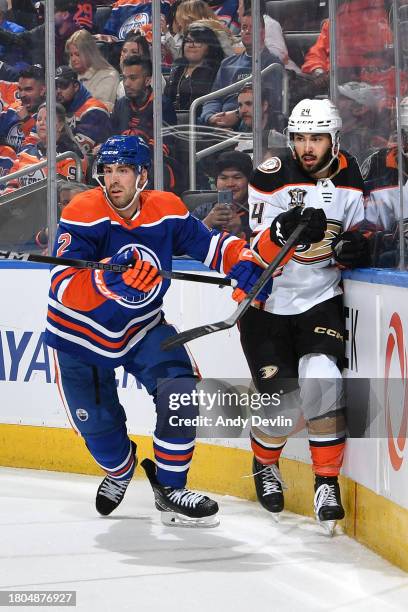 Evan Bouchard of the Edmonton Oilers collides with Bo Groulx of the Anaheim Ducks during the game at Rogers Place on November 26 in Edmonton,...