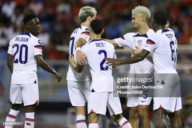 Antonee Robinson of the United States celebrates scoring with teammates during the first half against Trinidad and Tobago at Hasely Crawford Stadium...