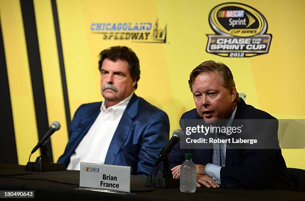 Brian France, chairman & CEO of NASCAR, and Mike Helton, president of NASCAR, speak during a press conference following practice for the NASCAR...