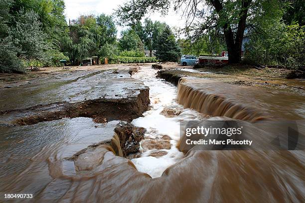 Water rushes down a flooded Topaz Street September 13, 2013 in Boulder, Colorado. Heavy rains for the better part of week has fueled widespread...