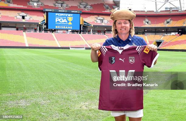 Cameron Smith poses for a photo with a Queensland State of Origin jersey after competing in a mowing challenge against fellow Australian golfer Marc...