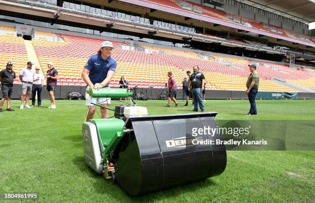 Cameron Smith competes in a mowing challenge against fellow Australian golfer Marc Leishman ahead of the 2023 Australian PGA Championship at Suncorp...