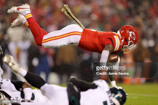 Jerick McKinnon of the Kansas City Chiefs dives over a defender during the first half of their game against the Philadelphia Eagles at GEHA Field at...
