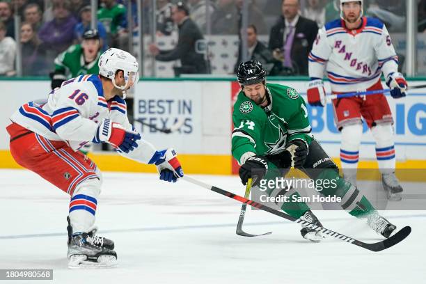 Vincent Trocheck of the New York Rangers and Jamie Benn of the Dallas Stars compete for the puck during the first period at American Airlines Center...