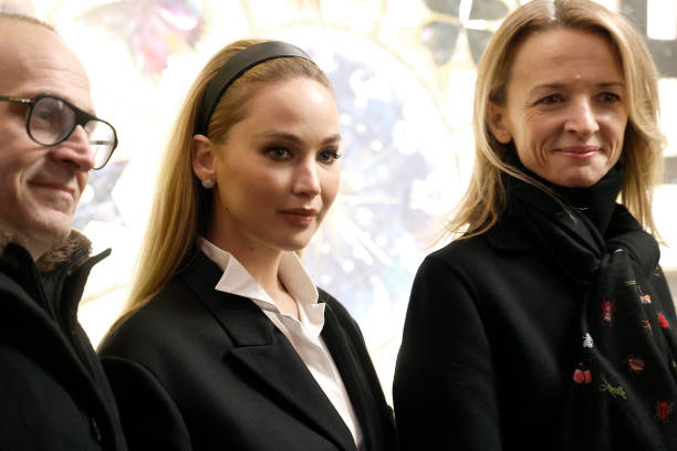 Marc Metrick, Jennifer Lawrence and Delphine Arnault attend Saks Fifth Avenue unveiling of 2023 holiday windows on November 20, 2023 in New York City.
