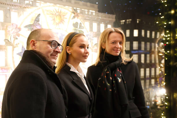 Marc Metrick, Jennifer Lawrence and Delphine Arnault attend Saks Fifth Avenue unveiling of 2023 holiday windows on November 20, 2023 in New York City.