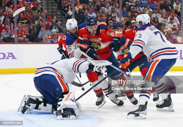 The Edmonton Oilers defend against Matthew Tkachuk of the Florida Panthers during the second period at Amerant Bank Arena on November 20, 2023 in...