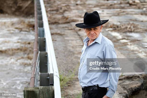 Jose Cortave of San Juan Sacatepequez, Guatemala takes a look at a damaged bridge on Weld County Road 1 on September 13, 2013 in Longmont, Colorado....