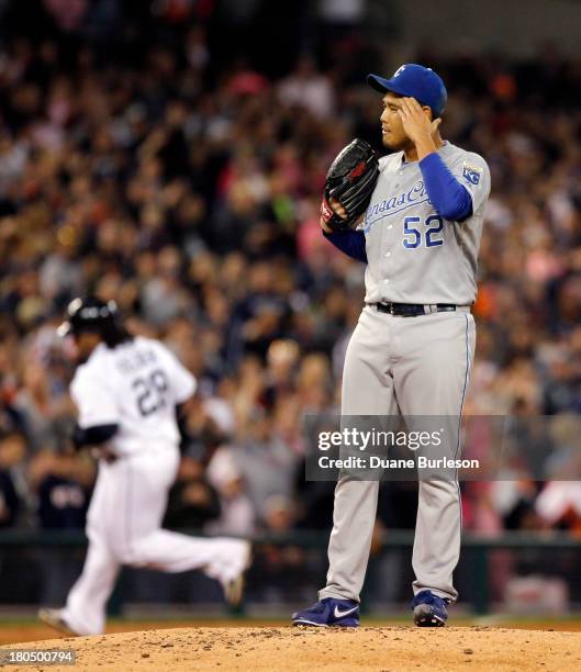 Bruce Chen of the Kansas City Royals wipes his brow as Prince Fielder of the Detroit Tigers rounds the bases after hitting a two-run home run in the...