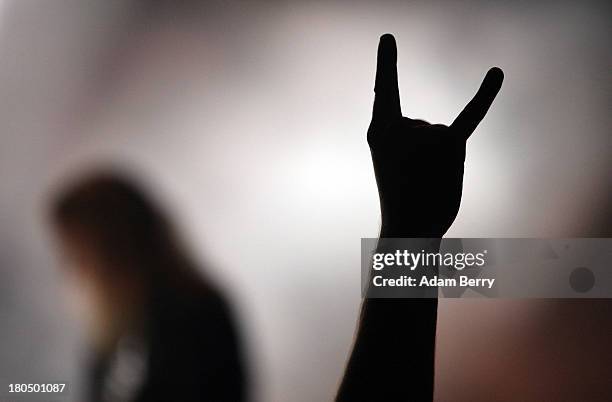 Fan gives the 'Devil's Horns' as Kreator performs during the fifth Metal Hammer Awards at Kesselhaus on September 13, 2013 in Berlin, Germany. The...