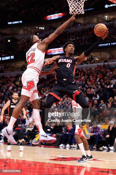Josh Richardson of the Miami Heat takes a shot over Ayo Dosunmu of the Chicago Bulls during the first half at the United Center on November 20, 2023...