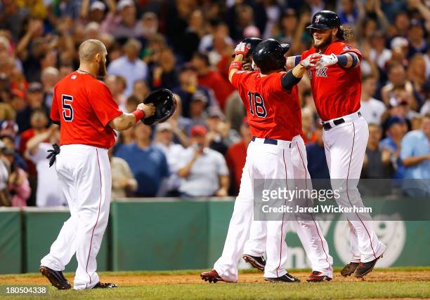 Jarrod Saltalamacchia of the Boston Red Sox is congratulated by teammates at home plate including Shane Victorino, David Ortiz, and Jonny Gomes of...