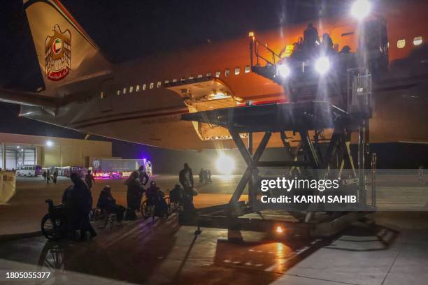 Palestinians evacuated from the Gaza Strip board a plane at Egypt's El-Arish International Airport bound for Abu Dhabi early on November 27 as part...