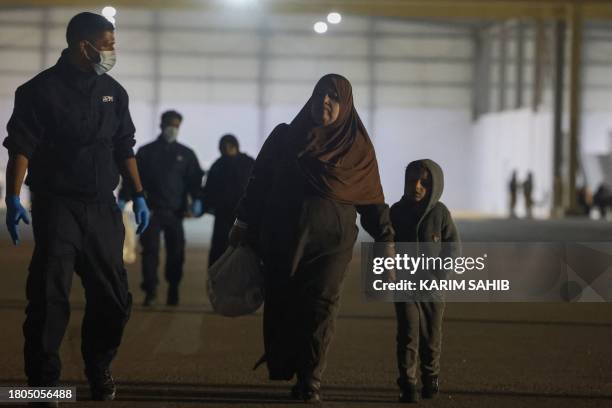 Palestinians evacuated from the Gaza Strip board a plane at Egypt's El-Arish International Airport bound for Abu Dhabi early on November 27 as part...