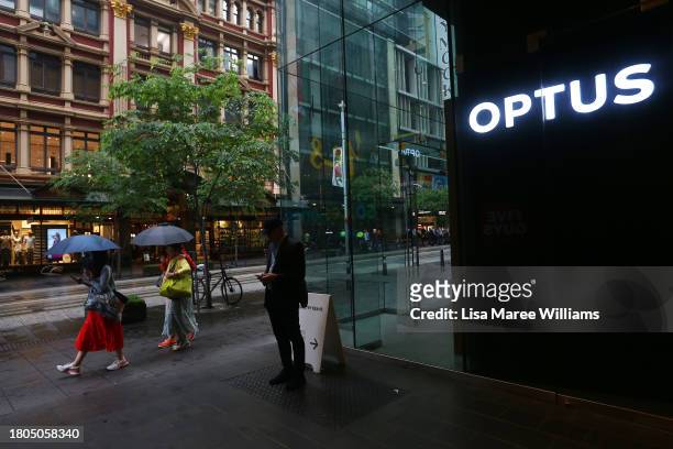 Pedestrians walk past an Optus store in the CBD on November 21, 2023 in Sydney, Australia. Optus' CEO Kelly Bayer Rosmarin stepped down on Monday...