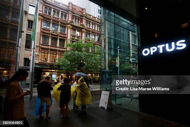 Pedestrians walk past an Optus store in the CBD on November 21, 2023 in Sydney, Australia. Optus' CEO Kelly Bayer Rosmarin stepped down on Monday...