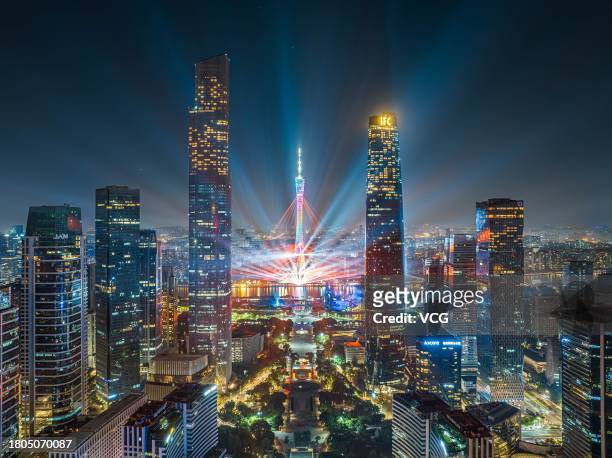 The Canton Tower and skyscrapers are illuminated during a rehearsal for the 2023 Guangzhou International Light Festival on November 20, 2023 in...