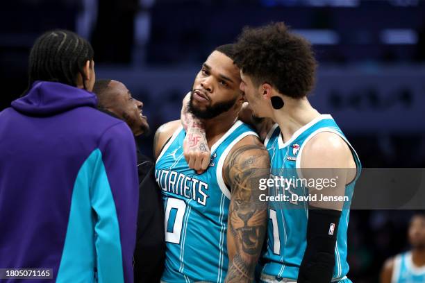 LaMelo Ball of the Charlotte Hornets reacts after Miles Bridges makes a three-pointer during the second half of an NBA game against the Boston...