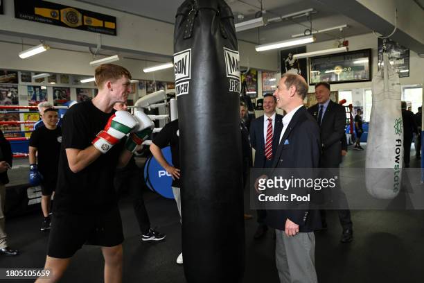 Prince Edward, Duke of Edinburgh, engages with 21 year old Marlon Sevehon from the Youth Boxing Program at the Police Citizens Youth Centre in...