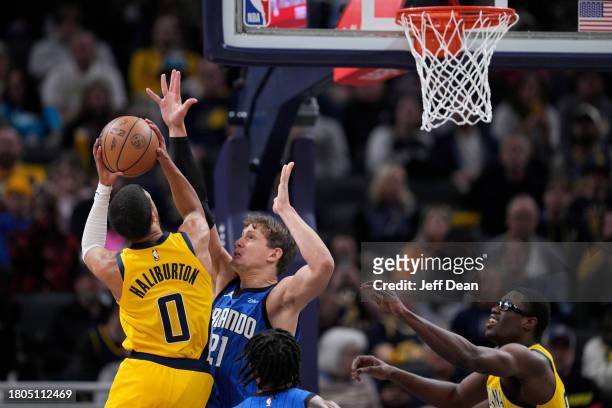 Tyrese Haliburton of the Indiana Pacers shoots against Moritz Wagner of the Orlando Magic at Gainbridge Fieldhouse on November 19, 2023 in...