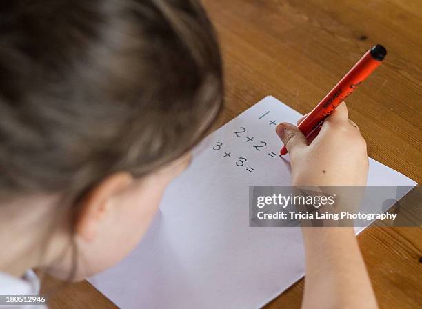 Child Working On Math Problem Photos and Premium High Res Pictures ...