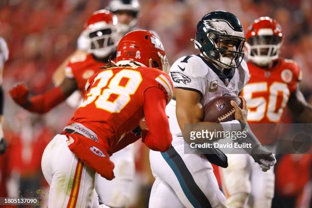 Jalen Hurts of the Philadelphia Eagles scambles past L'Jarius Sneed of the Kansas City Chiefs for a touchdown in the second half at GEHA Field at...
