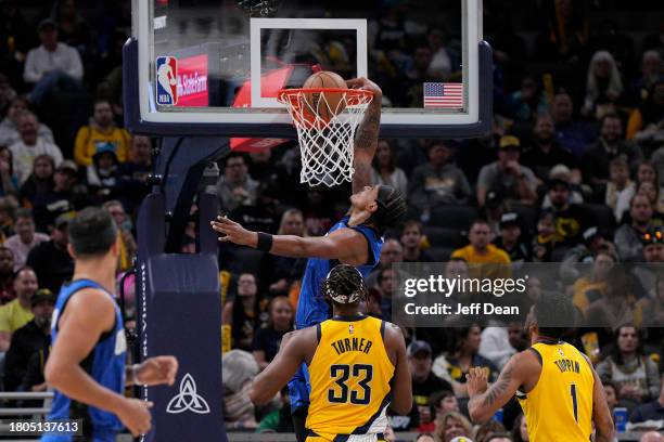 Paolo Banchero of the Orlando Magic dunks against Myles Turner of the Indiana Pacers at Gainbridge Fieldhouse on November 19, 2023 in Indianapolis,...