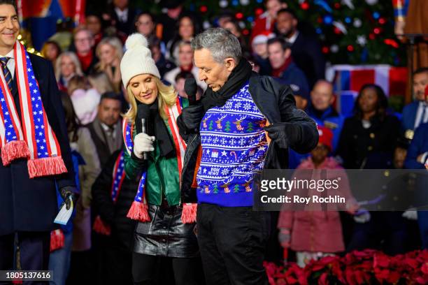 Dana Perino with Greg Gutfeld as he shows off his Fox News Christmas sweater as they host the Fox News 4th annual all-American Christmas Tree...