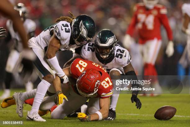 Travis Kelce of the Kansas City Chiefs fumbles the ball after being hit by Bradley Roby and Zach Cunningham of the Philadelphia Eagles in the second...