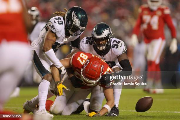 Travis Kelce of the Kansas City Chiefs fumbles the ball after being hit by Bradley Roby and Zach Cunningham of the Philadelphia Eagles in the second...