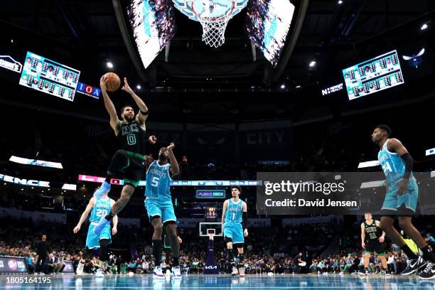 Jayson Tatum of the Boston Celtics lays the ball up during the second half of an NBA game against the Charlotte Hornets at Spectrum Center on...