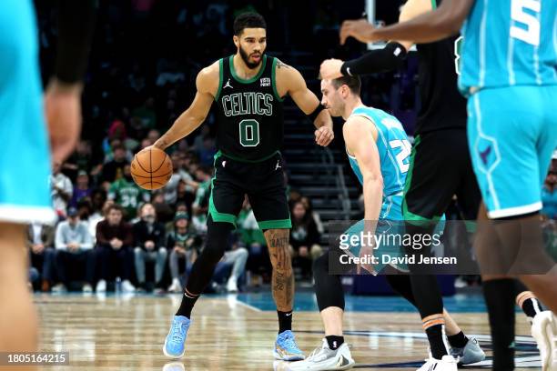 Gordon Hayward of the Charlotte Hornets defends Jayson Tatum of the Boston Celtics during the second half of an NBA game at Spectrum Center on...