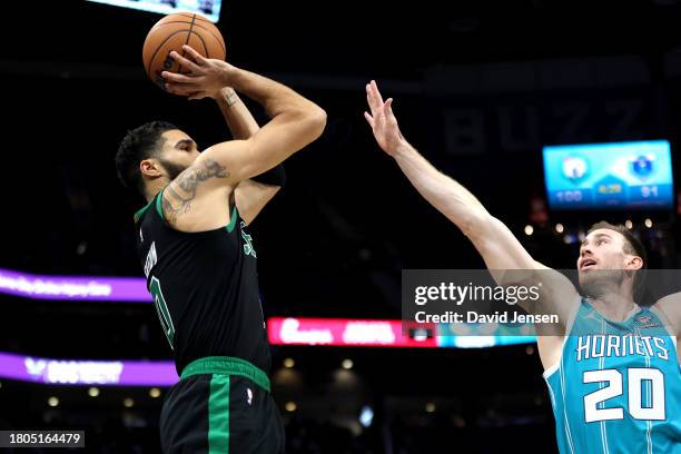 Gordon Hayward of the Charlotte Hornets defends a shot by Jayson Tatum of the Boston Celtics during the second half of an NBA game at Spectrum Center...
