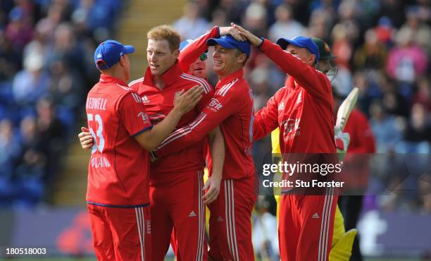 England bowler Ben Stokes and wicketkeeper Jos Buttler are congratulated after taking the wicket of Shaun Marsh during the 4th NatWest Series ODI...