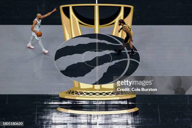 Derrick White of the Boston Celtics brings the ball up the court against Gary Trent Jr. #33 of the Toronto Raptors during the first half of their NBA...