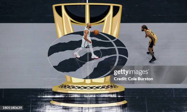 Derrick White of the Boston Celtics brings the ball up the court against Gary Trent Jr. #33 of the Toronto Raptors during the first half of their NBA...