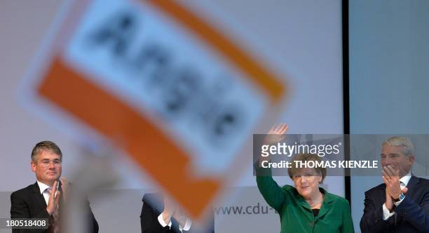 German Chancellor Angela Merkel waves to supporters after giving a speech at a regional convention of her Christian Democratic Union party in...