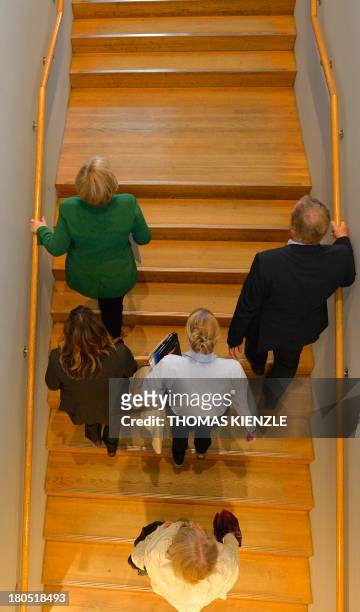 German Chancellor Angela Merkel walks up stairs during a regional convention of her Christian Democratic Union party in Heilbronn, southwestern...