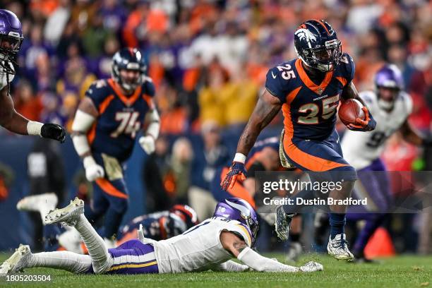 Samaje Perine of the Denver Broncos carries the ball against the Minnesota Vikings in the fourth quarter at Empower Field at Mile High on November...