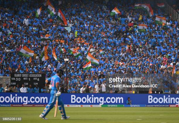 India fans watch on as Virat Kohli takes to the field during the ICC Men's Cricket World Cup India 2023 Final between India and Australia at Narendra...