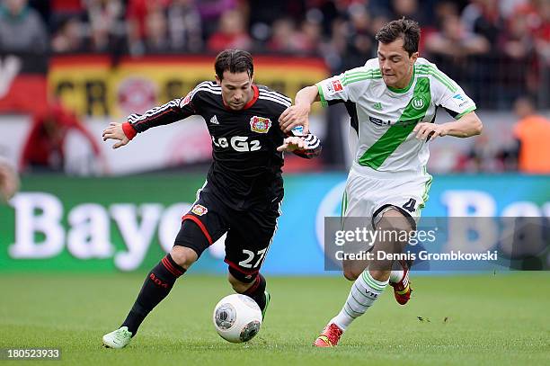Gonzalo Castro of Bayer Leverkusen and Marcel Schaefer of VfL Wolfsburg battle for the ball during the Bundesliga match between Bayer 04 Leverkusen...