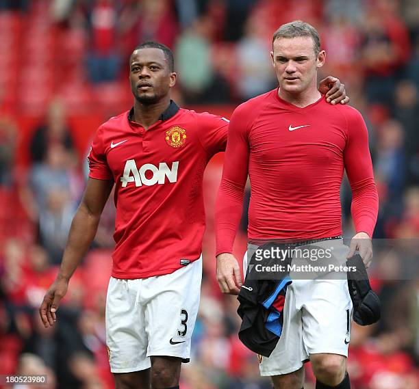 Patrice Evra and Wayne Rooney of Manchester United walk off after the Barclays Premier League match between Manchester United and Crystal Palace at...