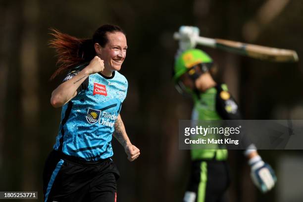 Meghan Schutt of the Strikers celebrates taking the wicket of Phoebe Litchfield of the Thunder during the WBBL match between Sydney Thunder and...