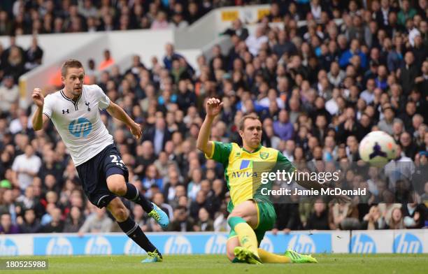 Gylfi Sigurosson of Spurs scores the opening past Steven Whittaker of Norwich City during the Barclays Premier League match between Tottenham Hotspur...