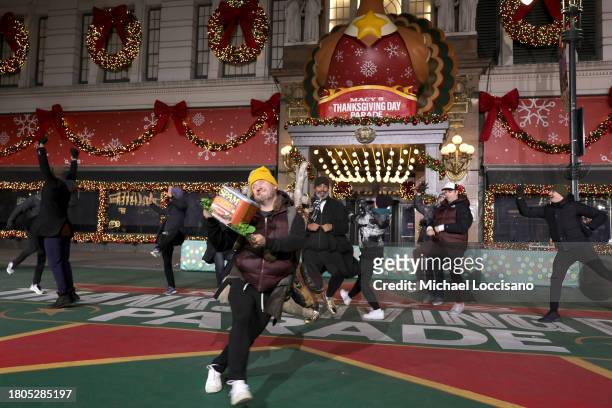 Christopher Fitzgerald and cast members from "Spamalot" perform during day one of 97th Macy's Thanksgiving Day Parade rehearsals at Macy's Herald...