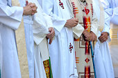Priests with folded hands.